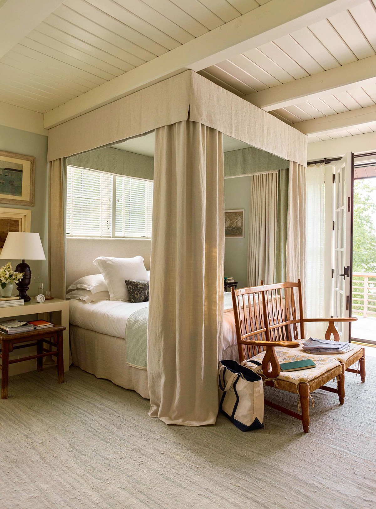 luxurious four posted fabric paneled bed in this maine cottage vacation home | design by gil schafer on coco kelley
