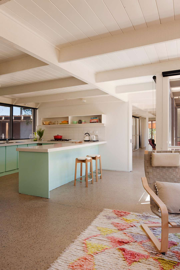 modern mint and white kitchen with pastel rug 