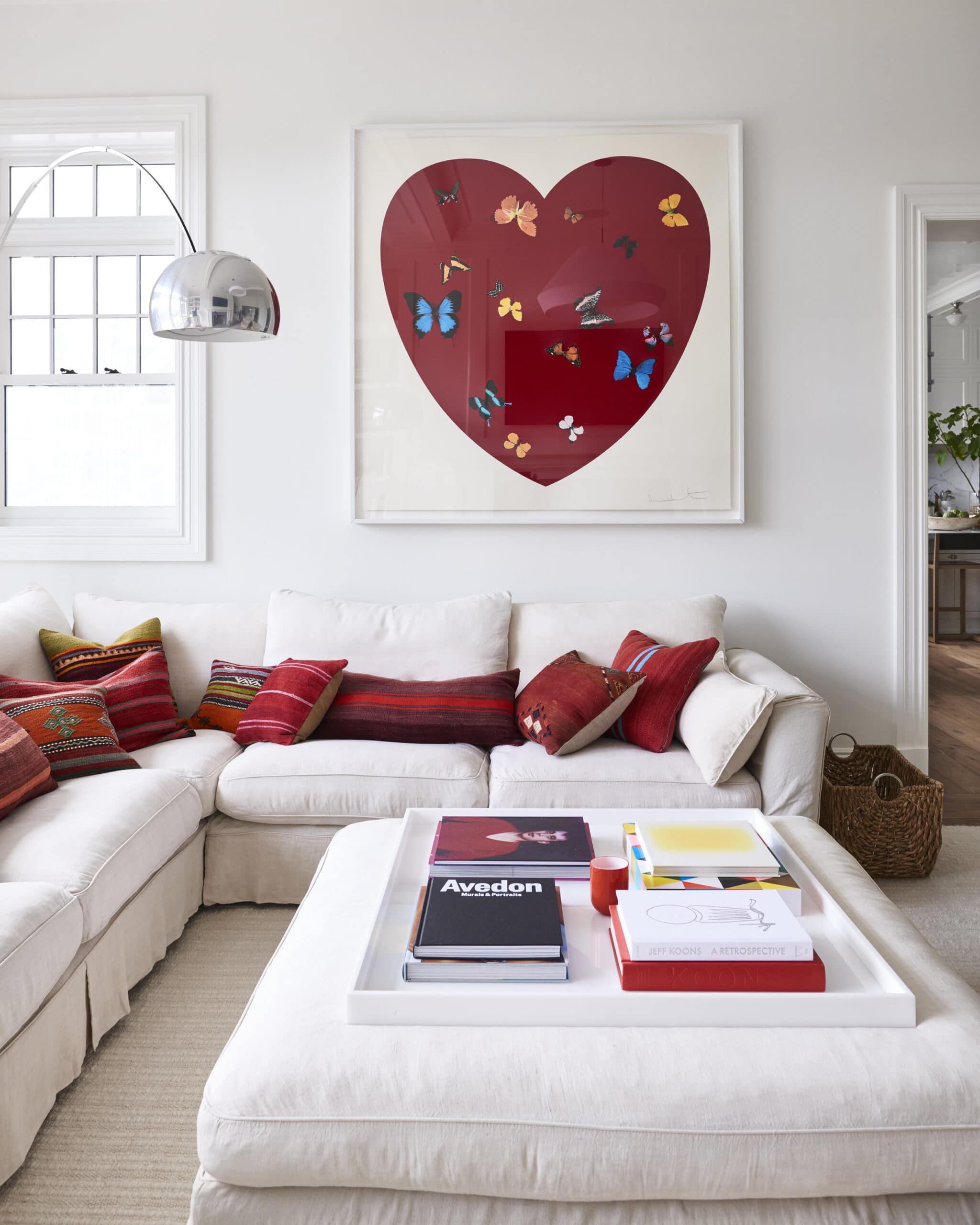 heart art in a red and white living room | coco kelley
