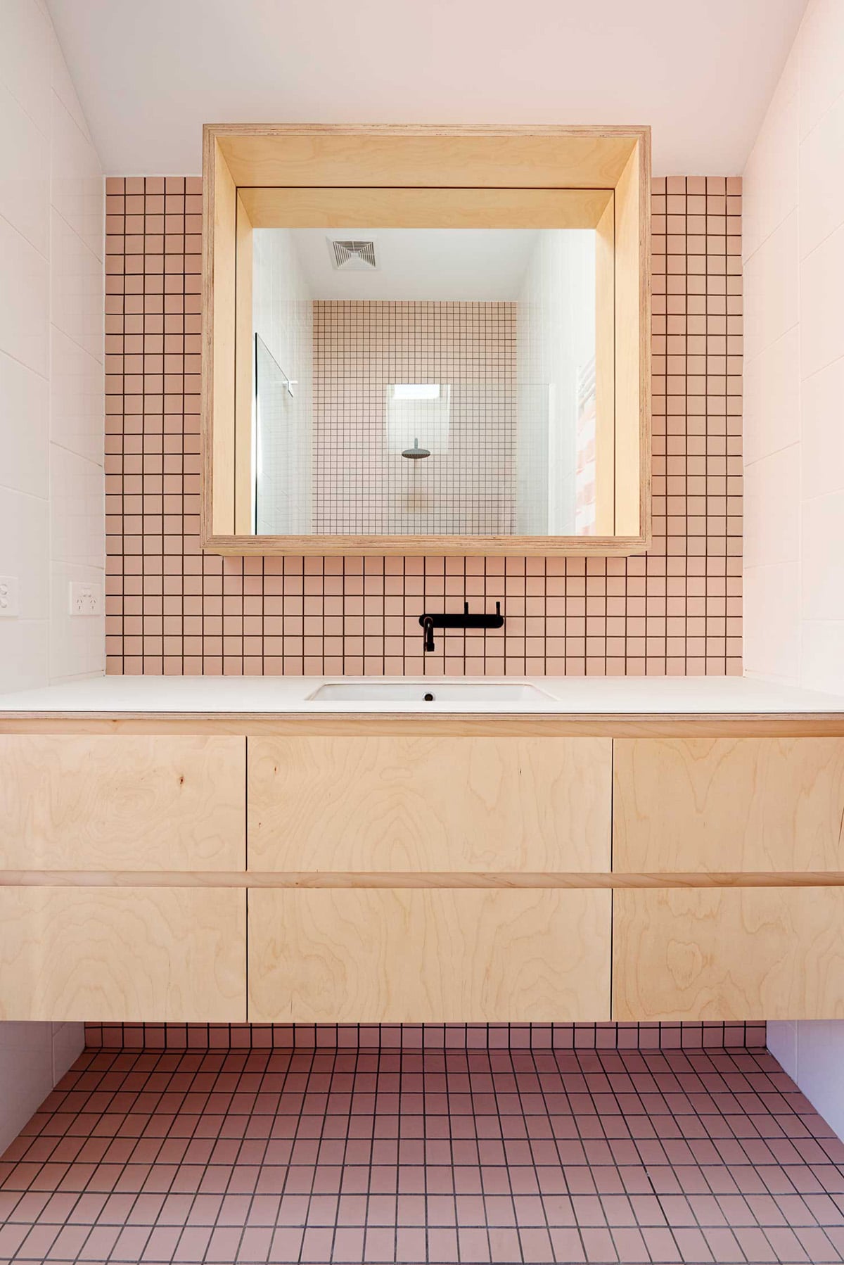pink square tiles, light wood, black fixtures in this modern bath | coco kelley