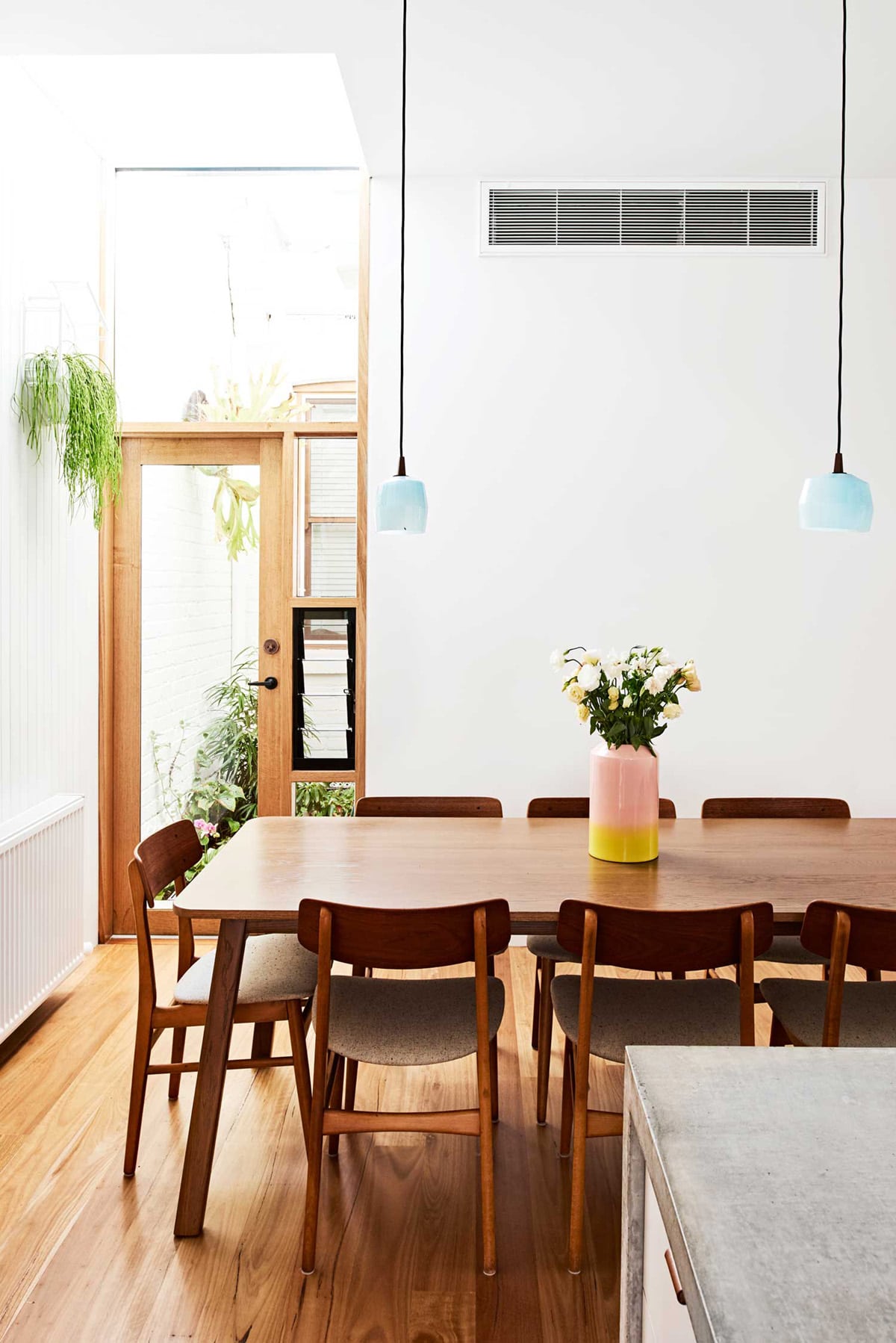 baby blue pendant lights in a modern wood dining room | coco kelley