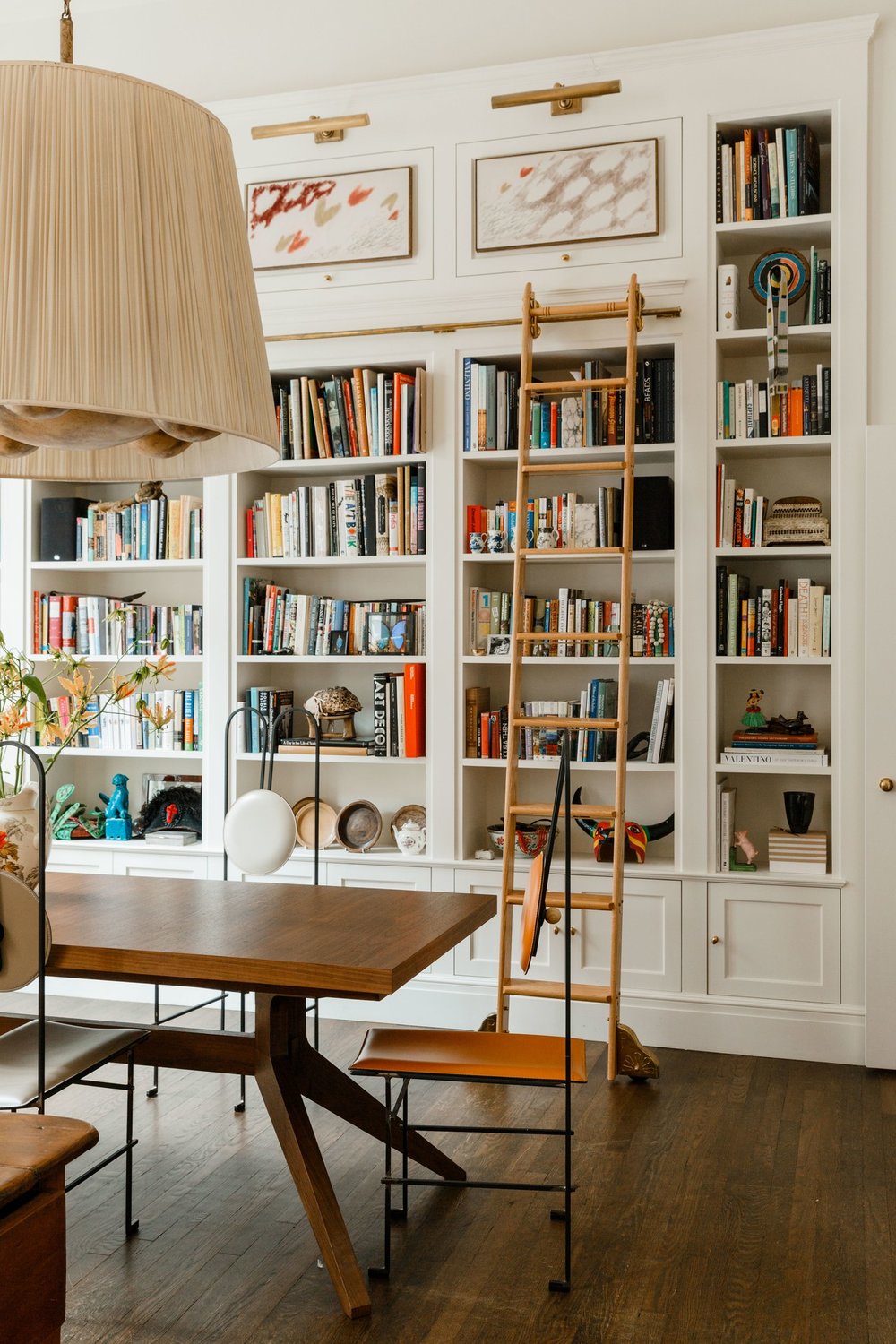 built in bookcase and library ladder in the dining room | james hirschfeld via arch digest