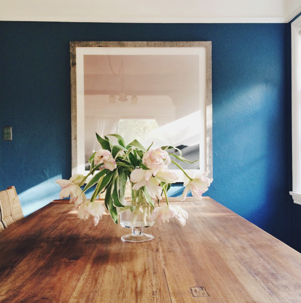 coco kelley dining room with blue walls rustic table and tulips // art via minted