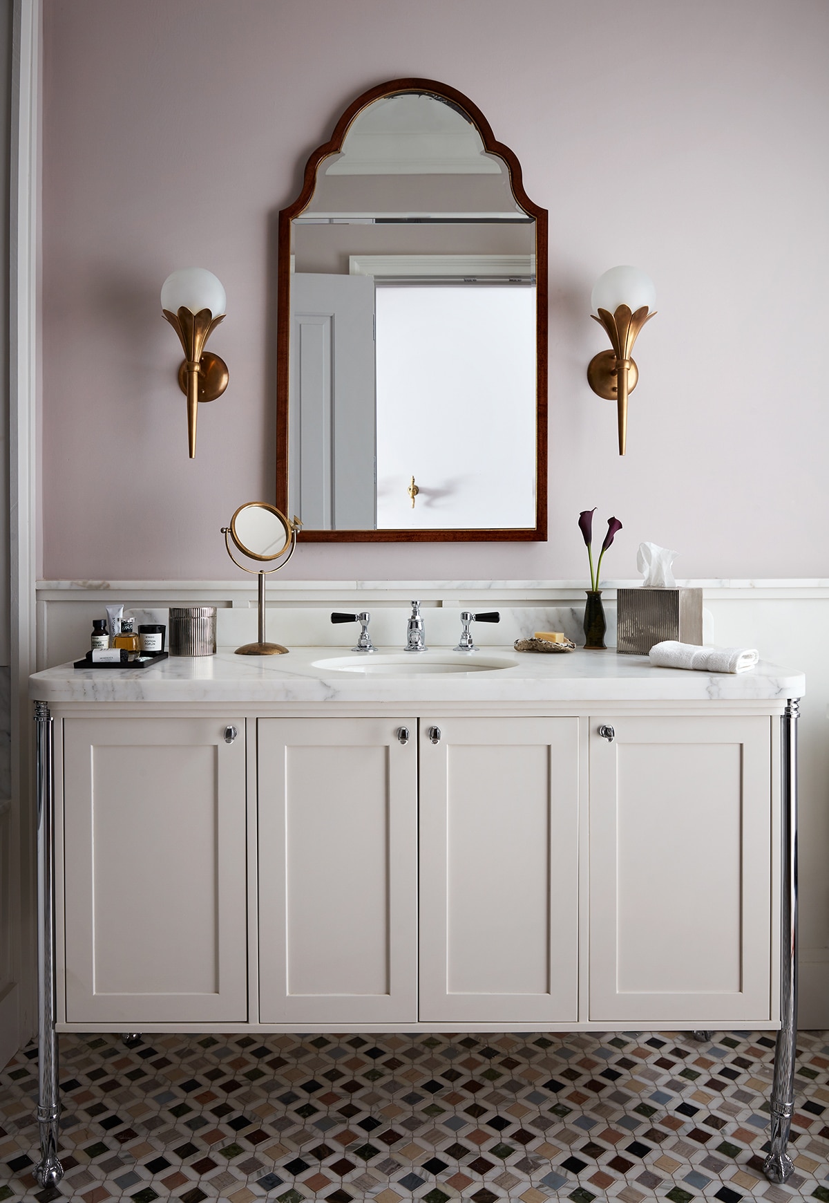 chic cream and mauve bath with marble accents and inlay tile floors