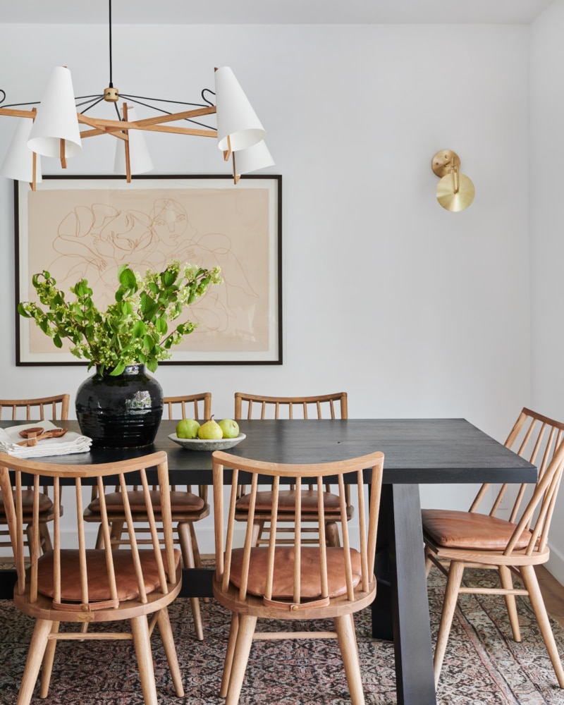 oak dining chairs with leather cushions and black table | amber interiors