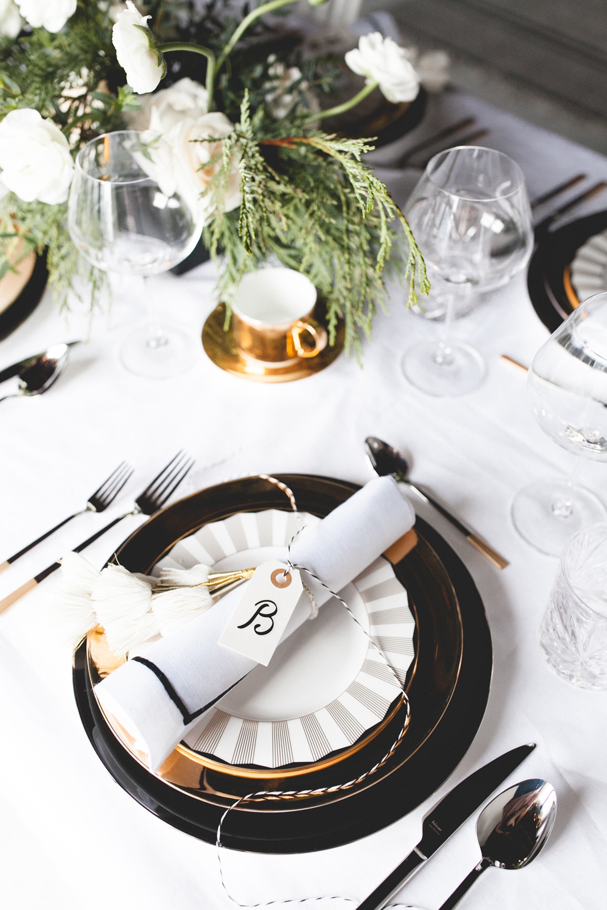 a black tie holiday tabletop setting with gold details | by coco kelley