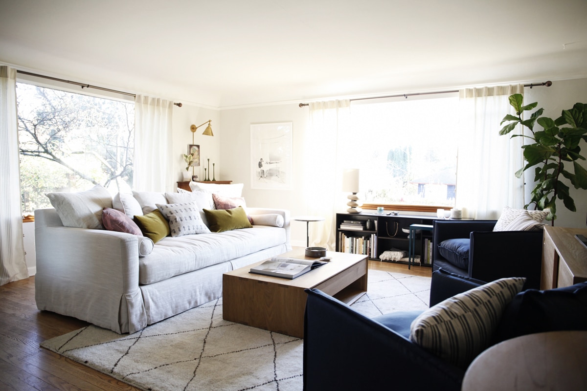 our sun-filled living room with warm woods and white | coco kelley