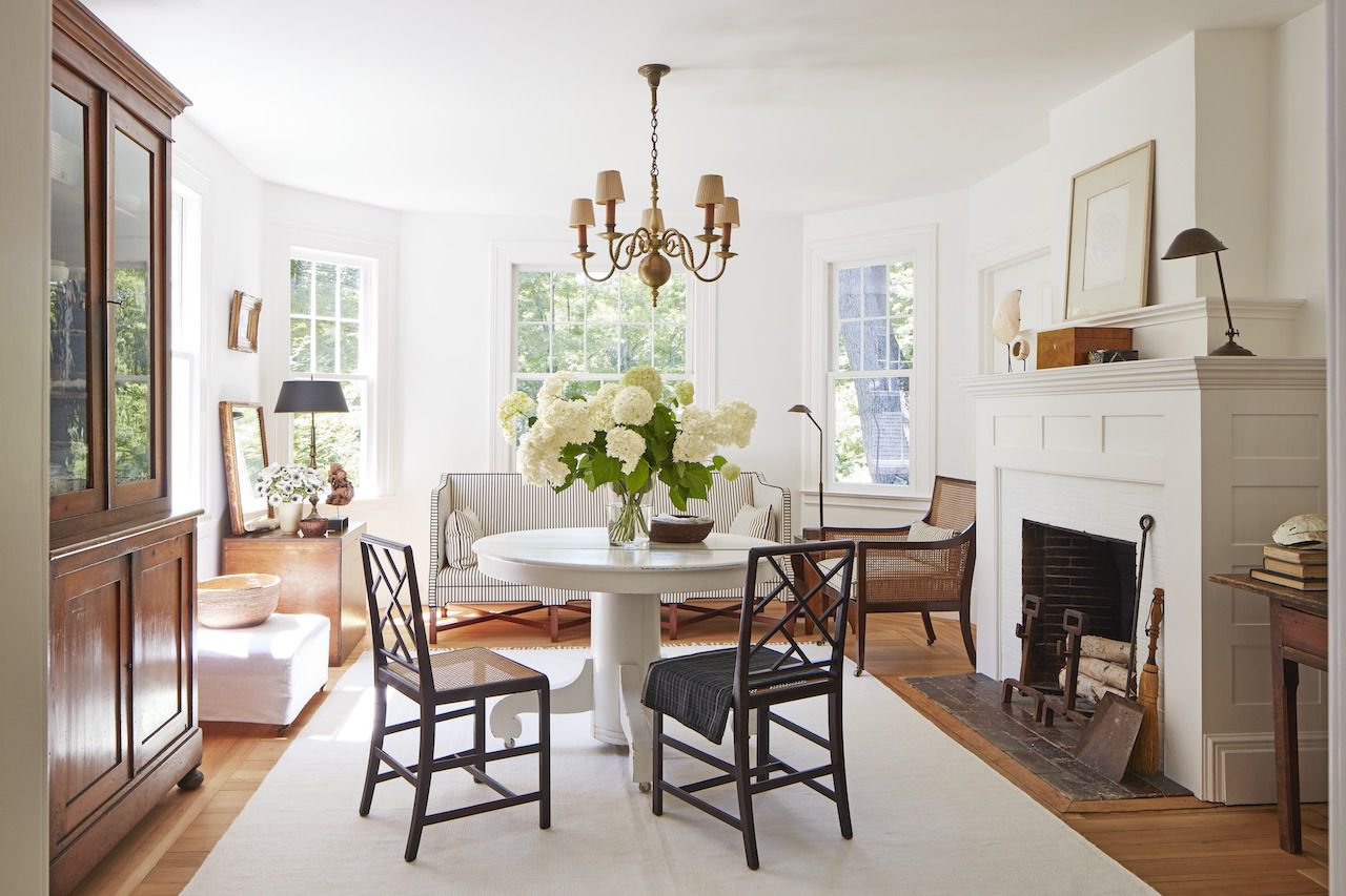 a classic connecticut cottage in white and wood - round dining room | house tour on coco kelley