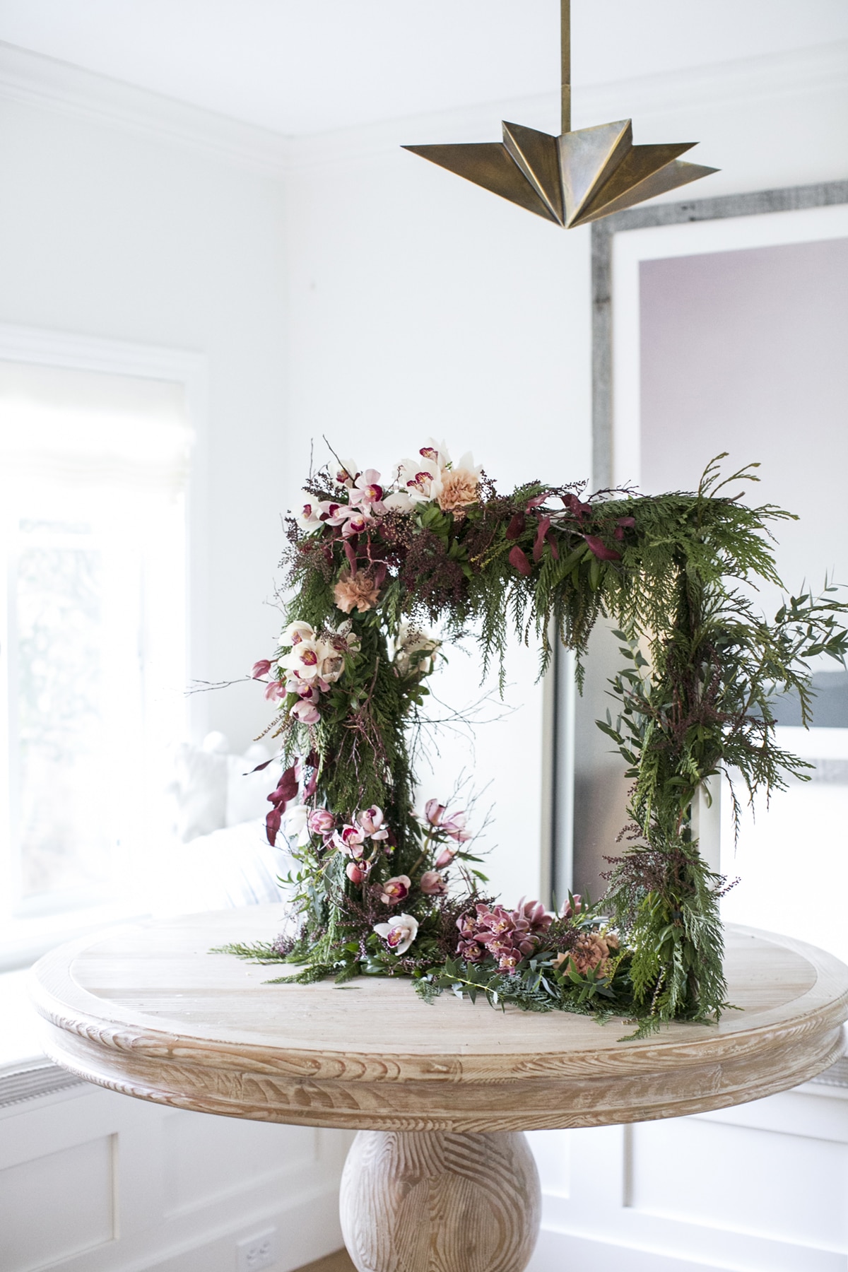how to make this gorgeous holiday garland mirror with orchids and greenery | DIY tutorial on coco kelley