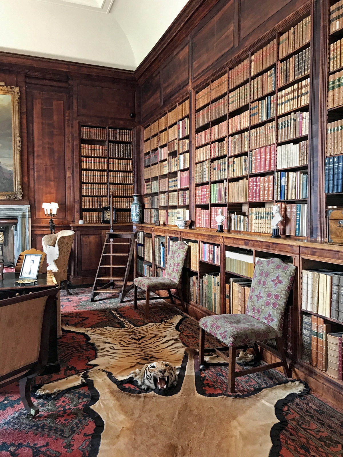 a library in Dunrobin Castle Scotland with animal hide rugs | tour on coco kelley