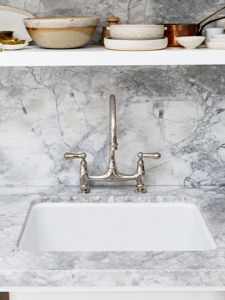 a small sink in waterfall marble | backyard photo studio kitchen tour on coco kelley