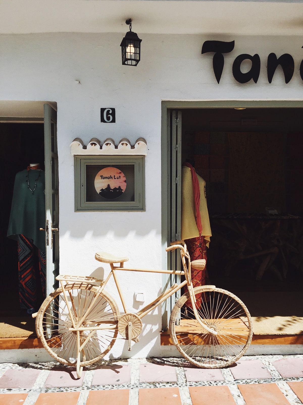 a wicker bicycle sits outside a chic shop in marbella spain | see our guide to the costa del sol on coco kelley
