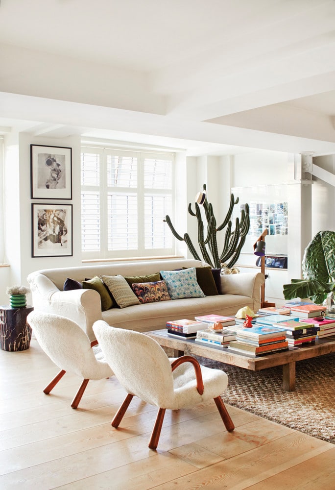 alex eagle modern london loft with shearling chairs huge coffee table white sofa and large cactus in the living room | coco kelley