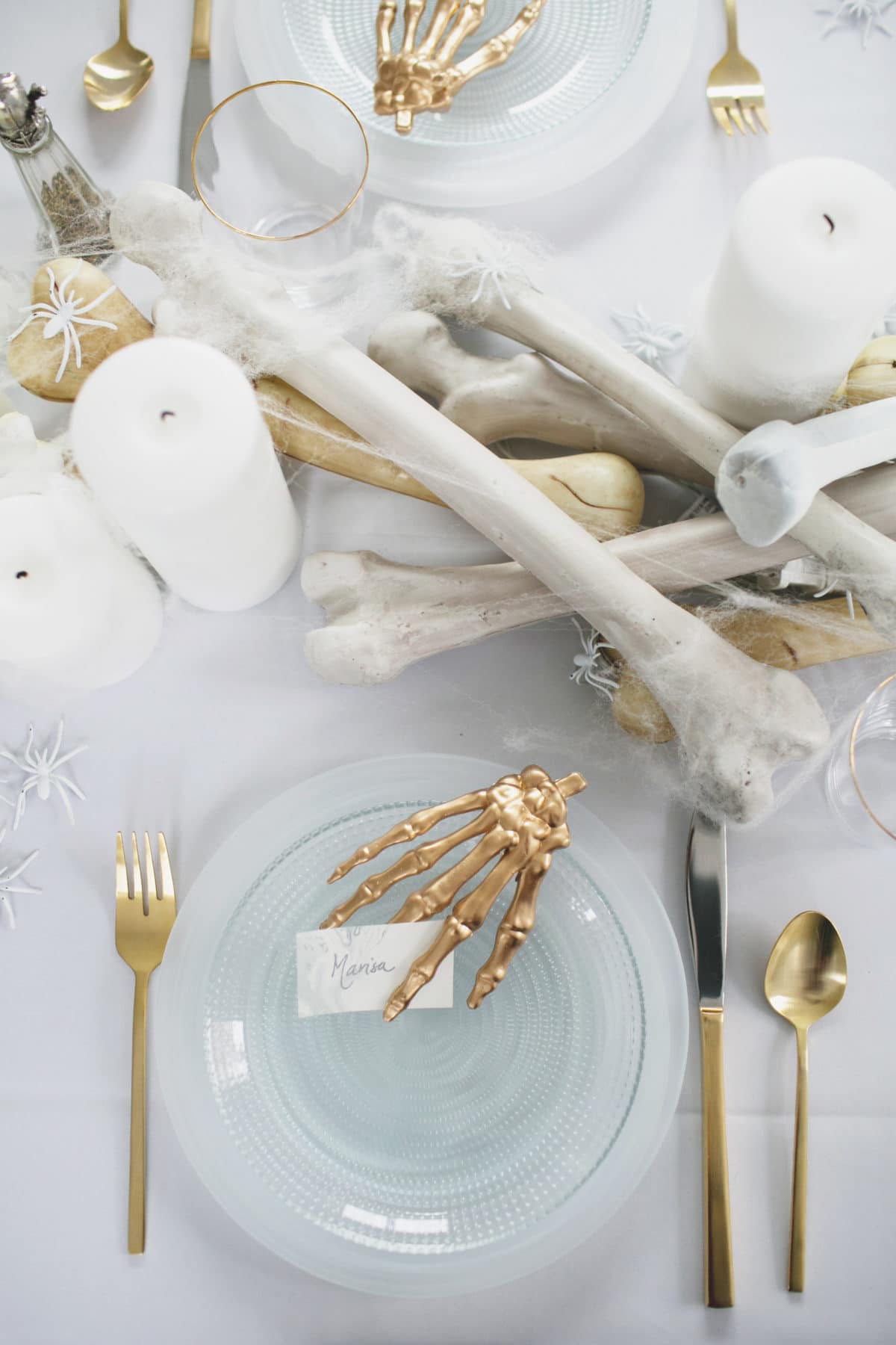 an all white ghostly halloween tabletop with bone and candle centerpiece runner | coco kelley