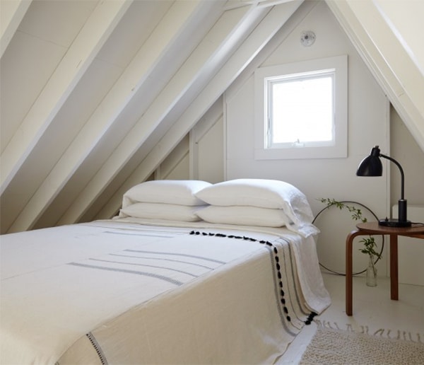 an all white loft attic bedroom in a minimal beach cabin house tour | via coco kelleyjpg