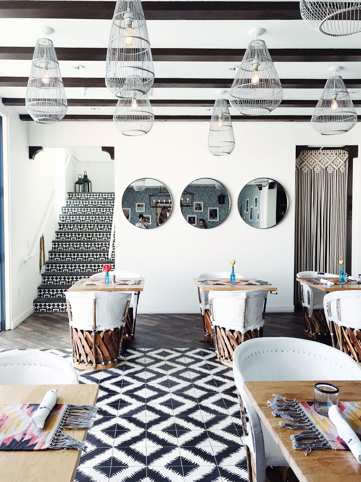 bold black and white tile and white equipal chairs at azucar restaurant | tour of la serena villas on coco kelley