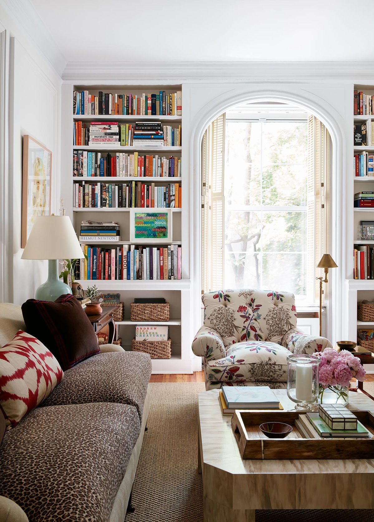 beautiful built in bookcases and a leopard print sofa in this classic apartment living room | room of the week via coco kelley