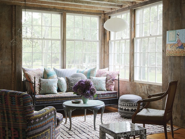 beautiful layered textiles in a moody living room nook - refined boheme house tour via coco kelley