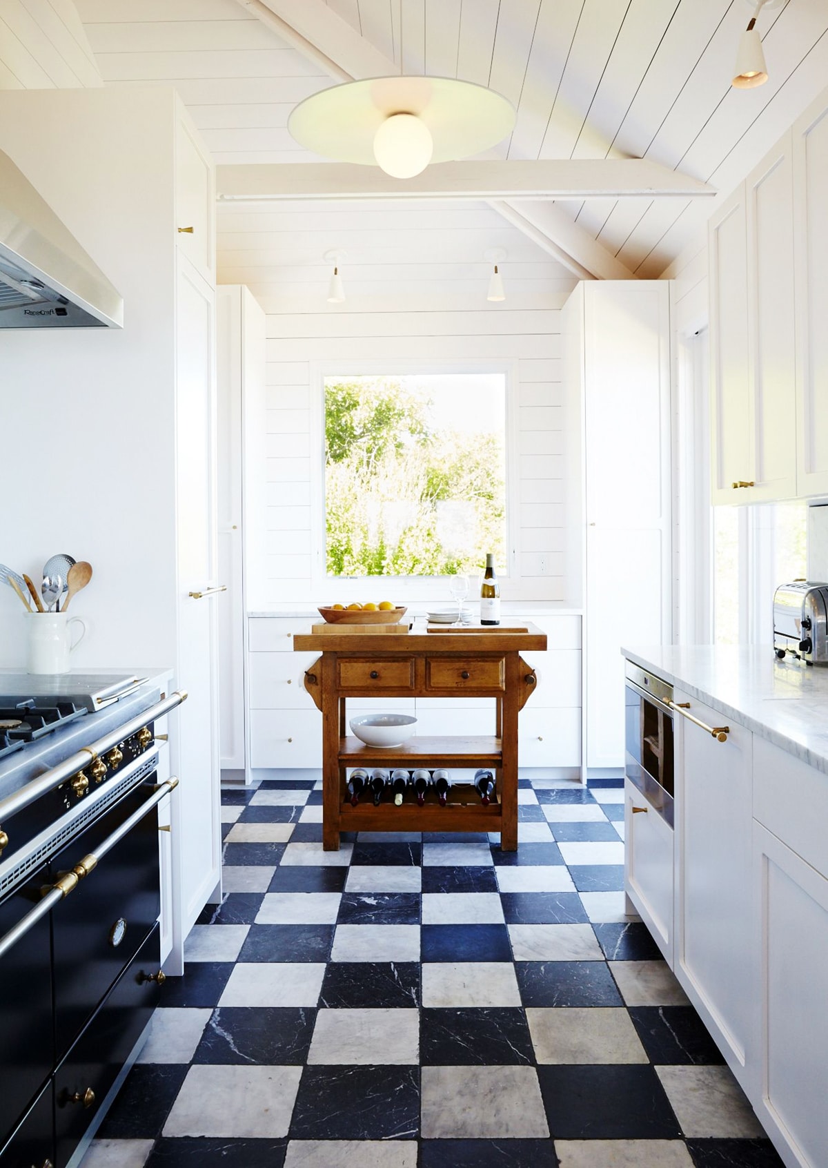 black and white marble checkered floors in modern farmhouse kitchen