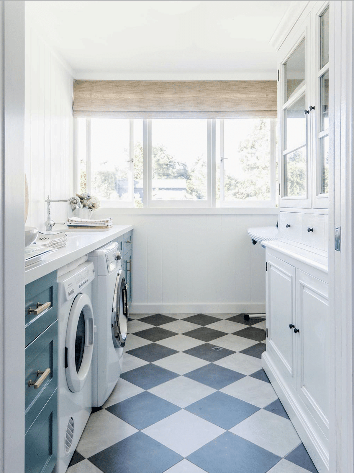 bright laundry room with blue cabinets and black and white checkerboard floors by cottonwood and co | via coco kelley