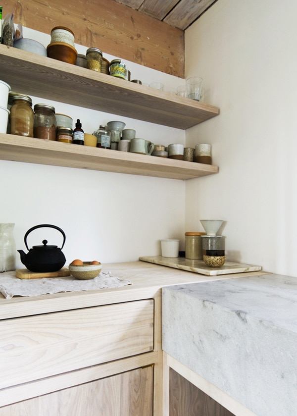 light wood cabinets and open shelving with marble in this modern scandinavian style kitchen | via coco+kelley