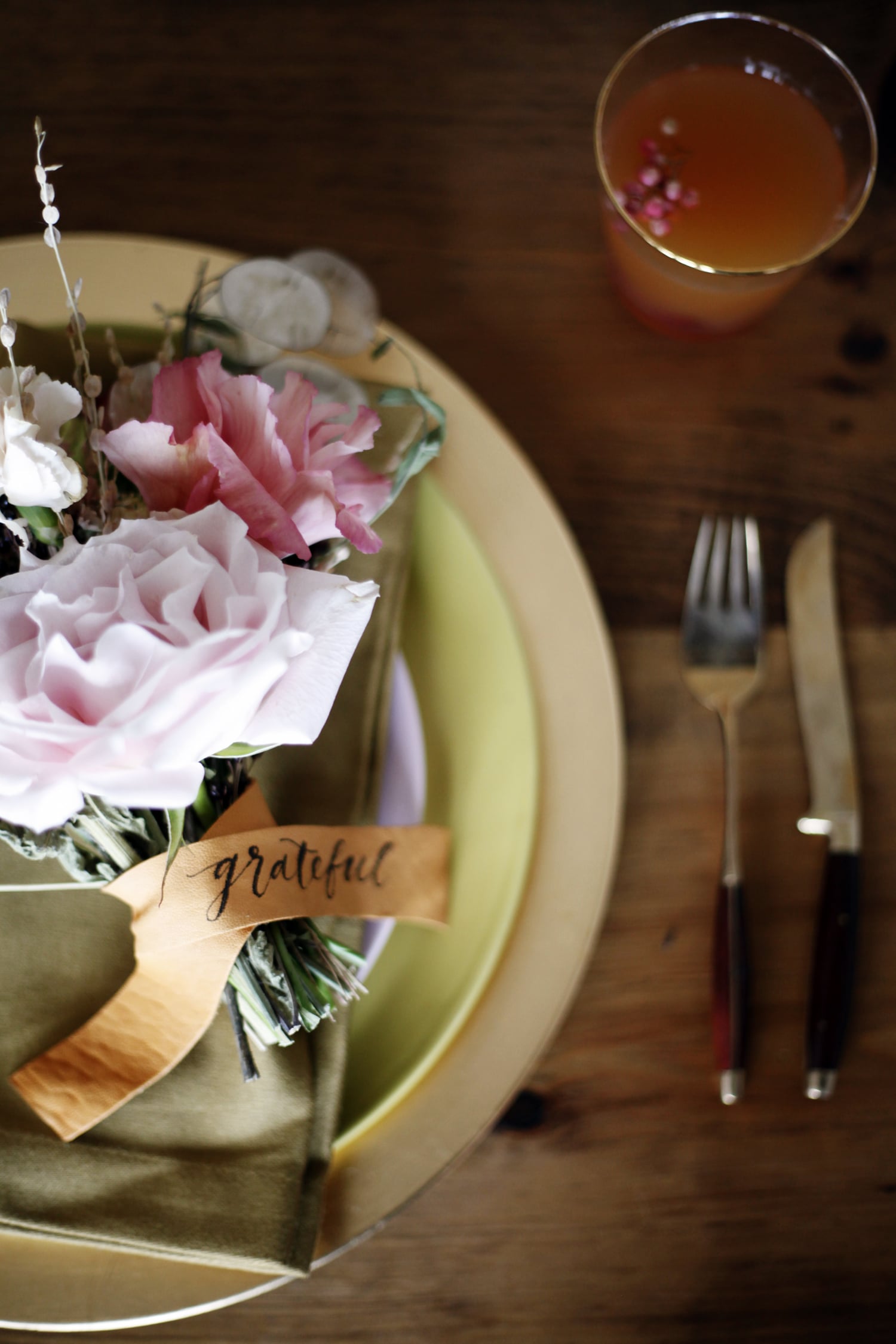 calligraphy on leather wrapped around mini bouquets for each Thanksgiving place setting | via coco kelley
