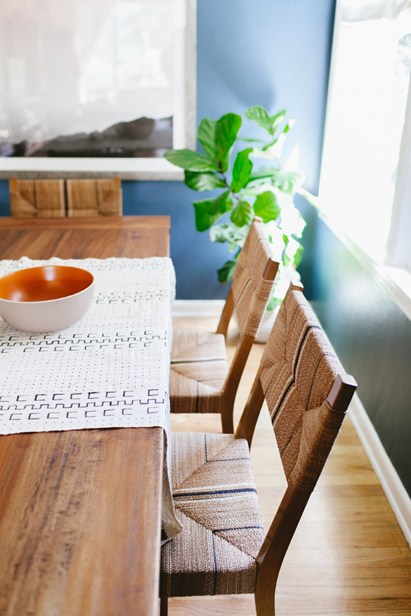 woven chairs and wood dining table with mud cloth runner // coco+kelley