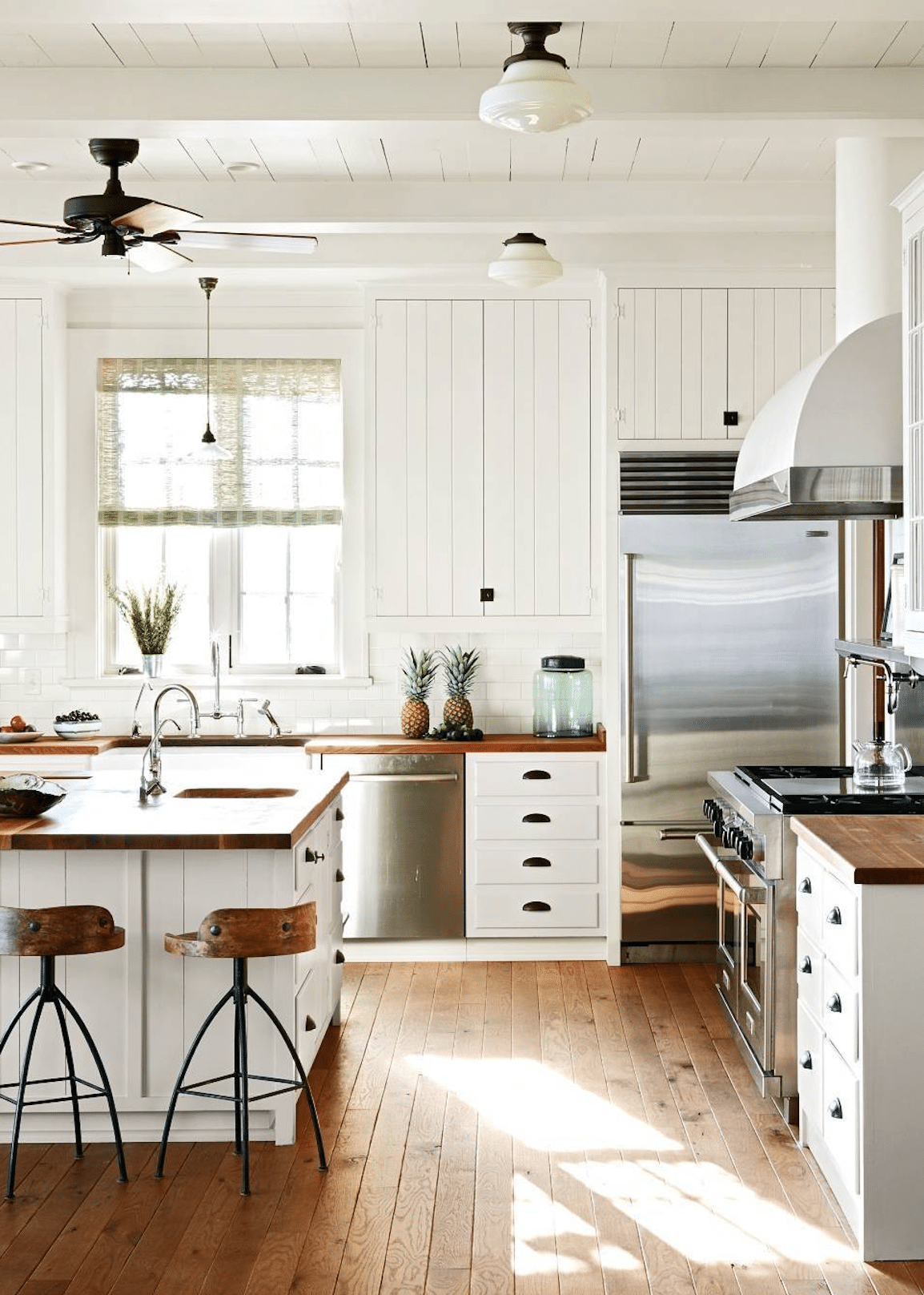 classic farmhouse kitchen with wood countertops | via coco kelley