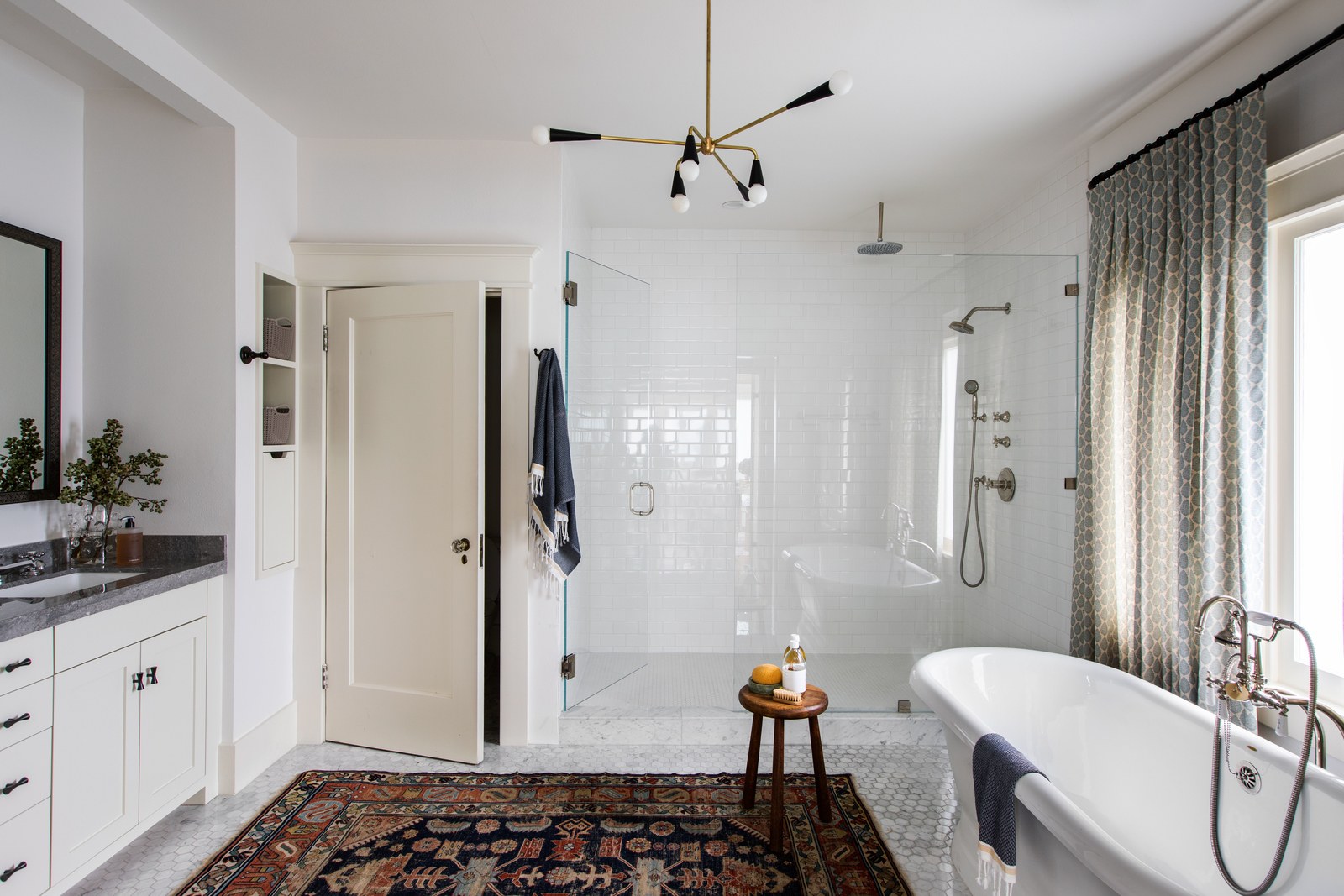 classic white bath with vintage rug | modern historic craftsman house tour jacey duprie