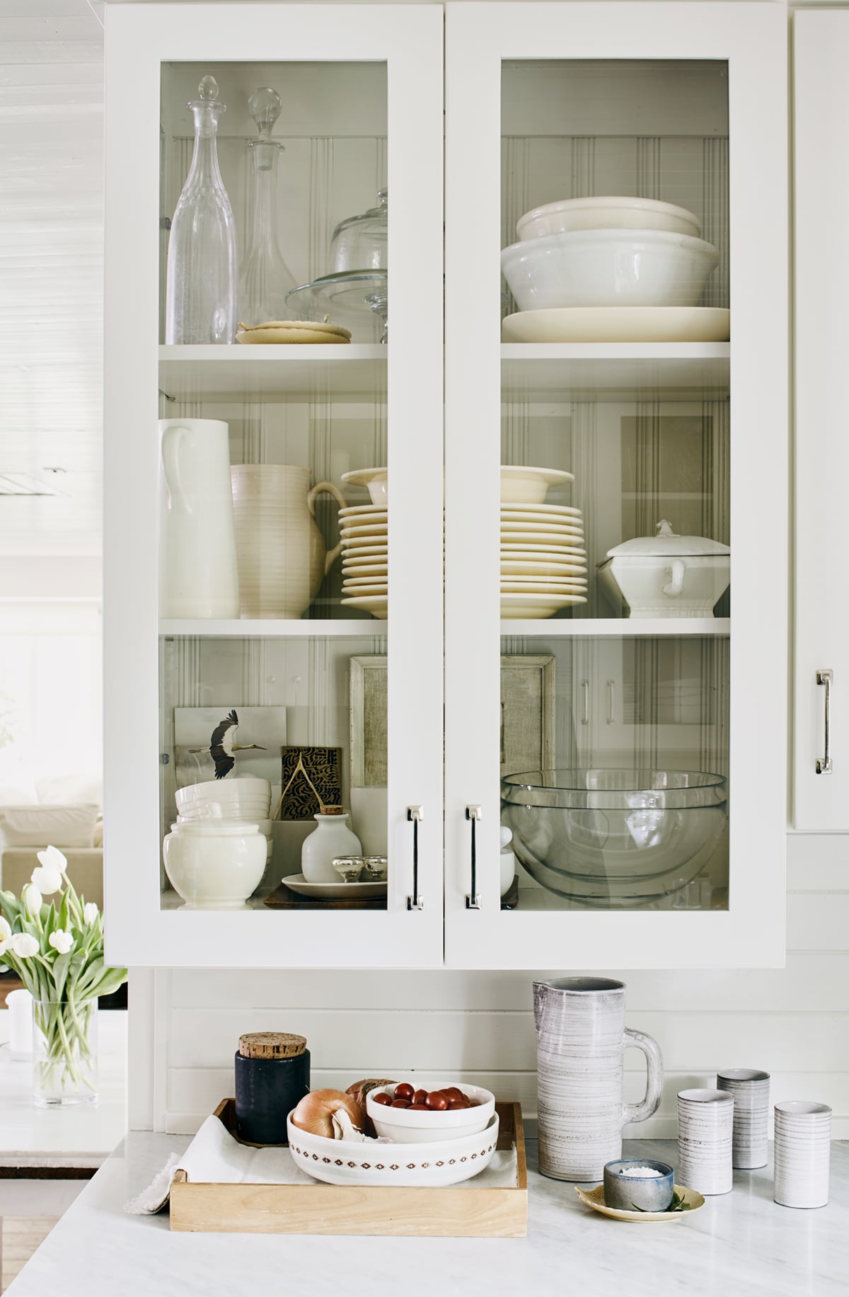 classic white glassfront cabinets show off collections in the kitchen | relaxed ranch house tour on coco kelley