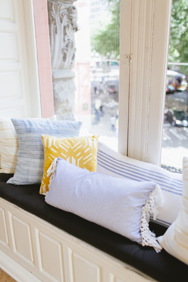blue and yellow pillows in the window seat | coco+kelley