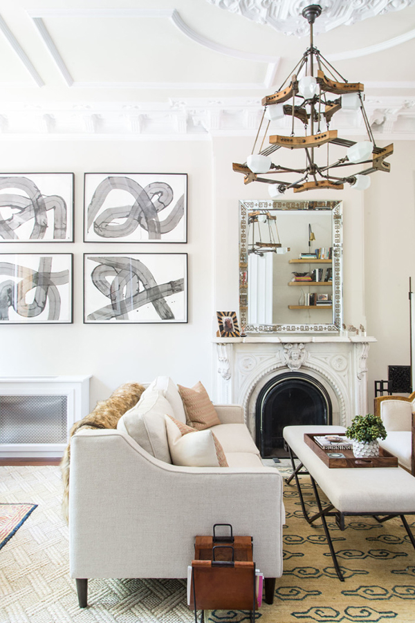 an eclectic mix in neutrals (check out that funky chandelier!) in this fabulous living room | brooklyn brownstone home tour via coco kelley