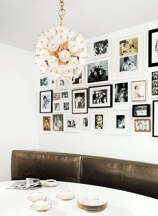 leather banquette dining nook with mod chandelier and family photo wall | via coco+kelley