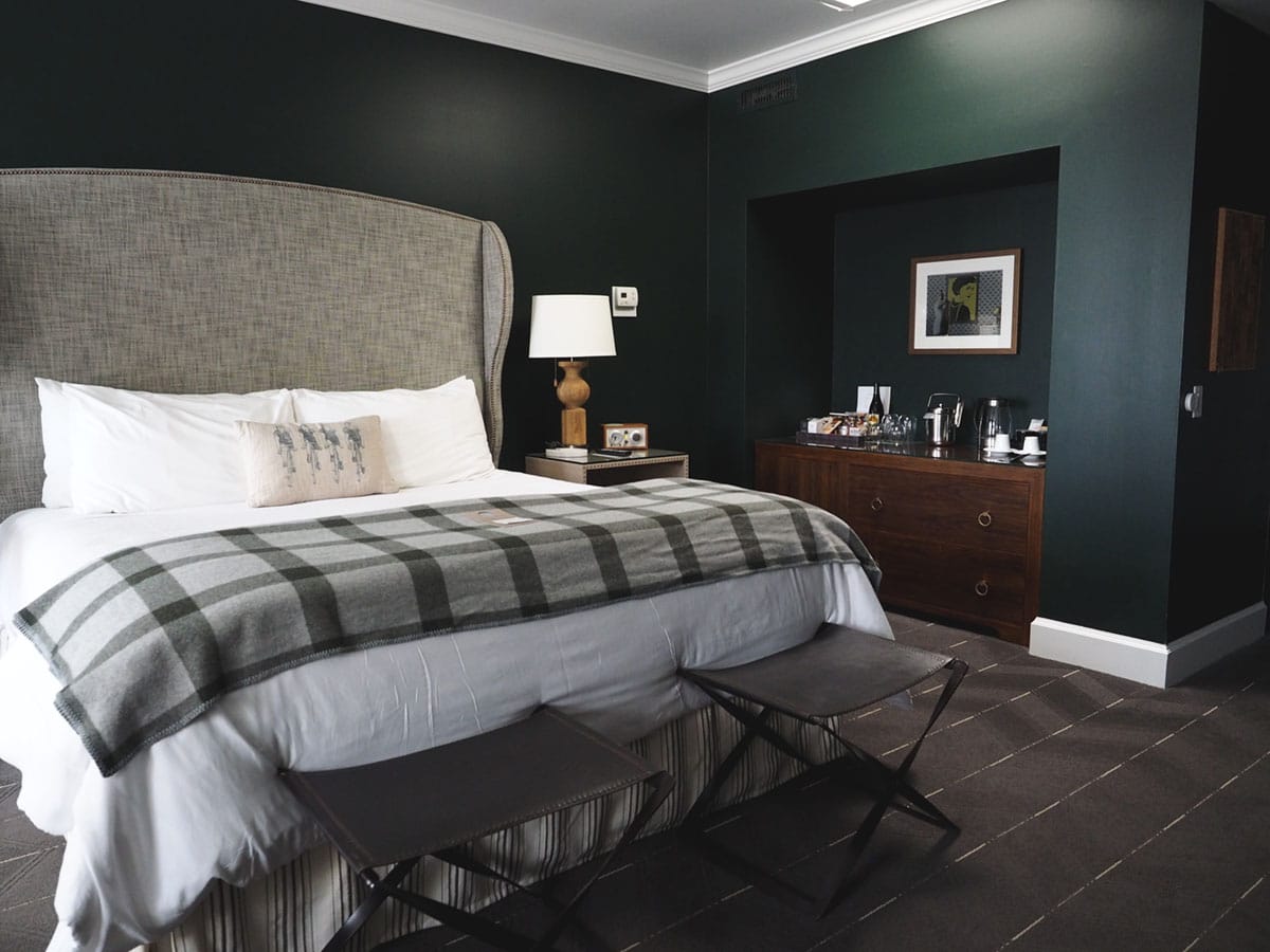 cozy linens and dark green walls at the Sentinel Hotel in Portland