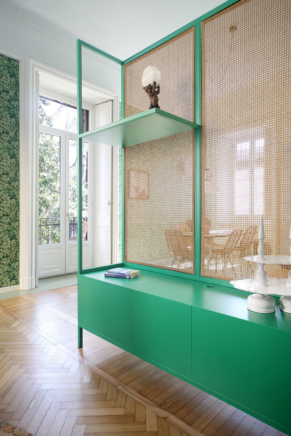 custom cane storage and room divider in lush green - milan apartment | coco kelley
