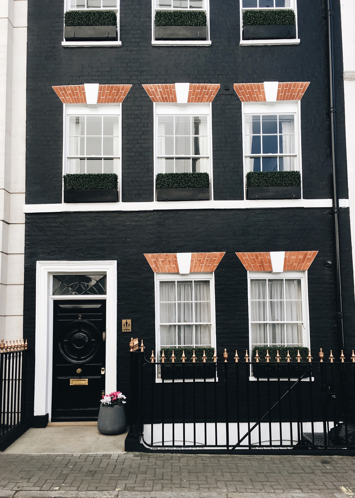 a dark grey exterior row house in London | 48 hour travel guide via coco kelley