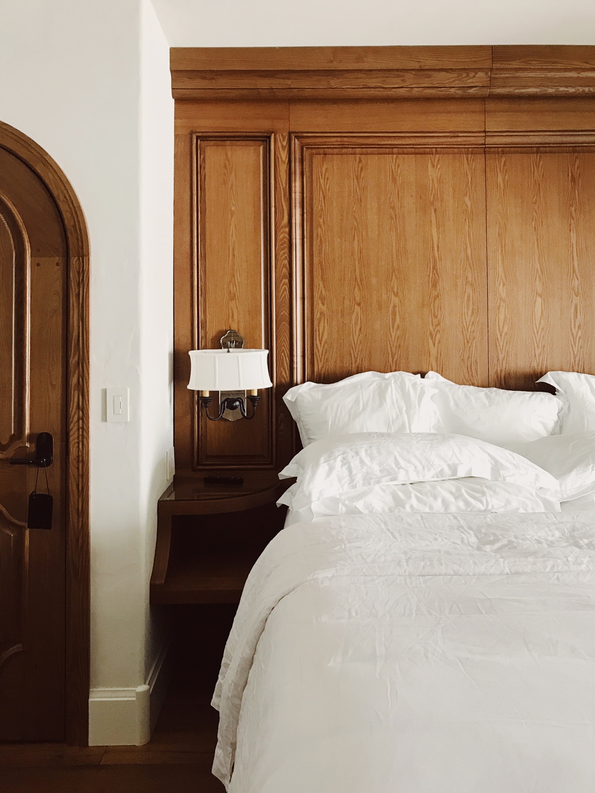 fluffy white bedding and wood built-in headboard at the posthotel in leavenworth | coco kelley