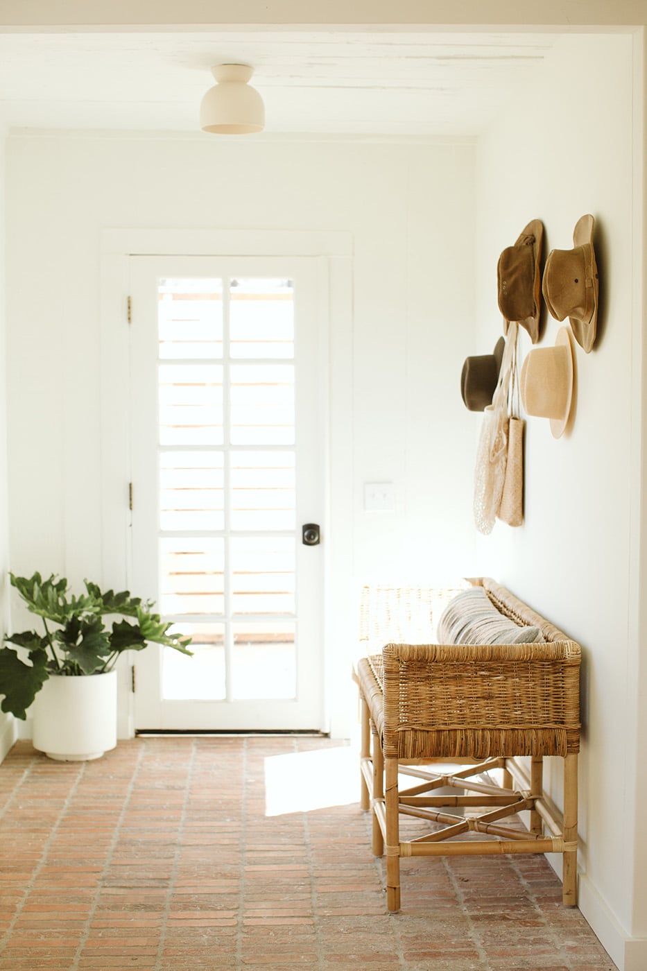 entryway with hats and woven bench | bodega house los alamos