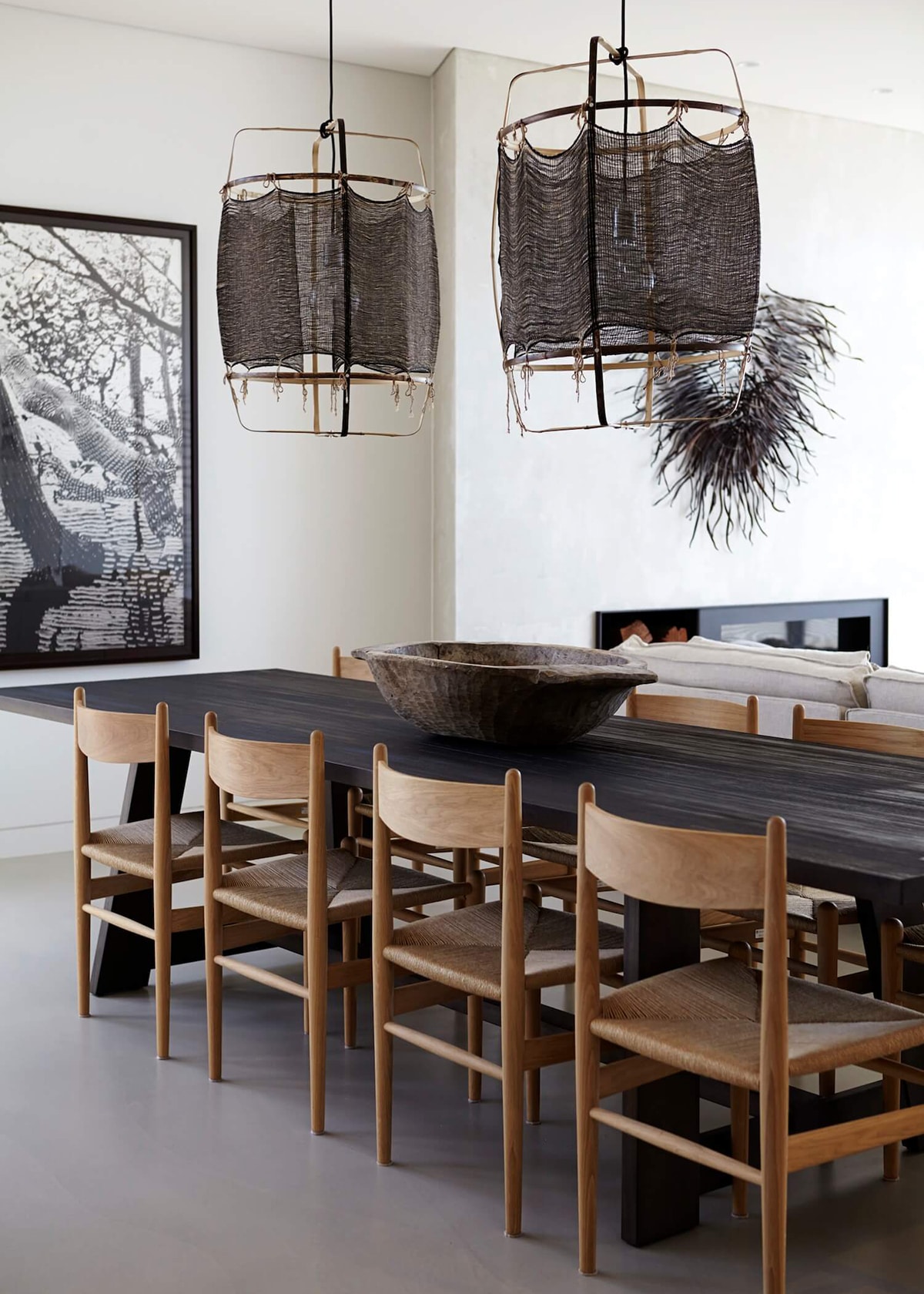 black table and oak dining chairs with fabric pendants