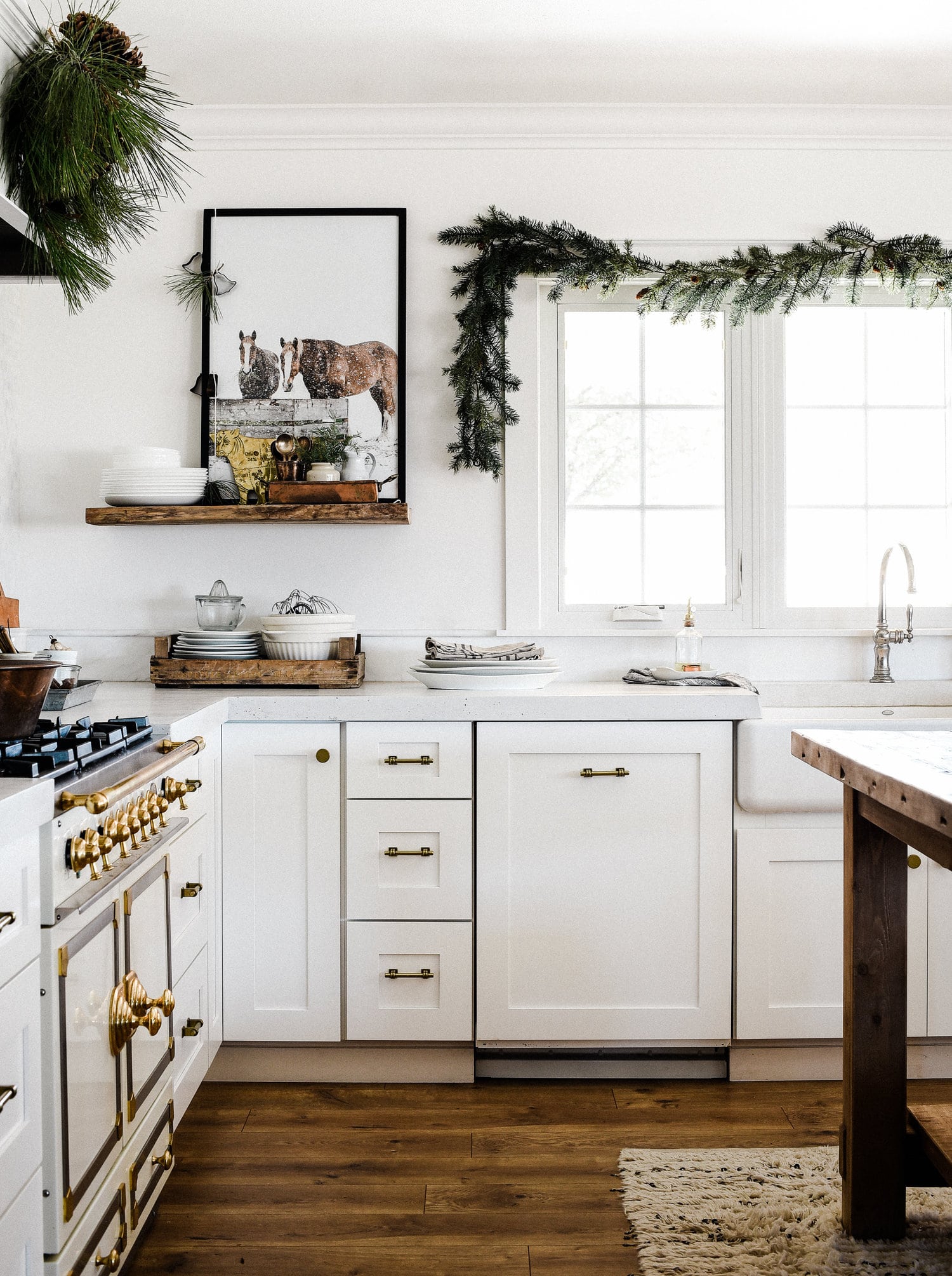 farmhouse kitchen decorated for the holidays with greenery garland | our favorite holiday home decor ideas on coco kelley