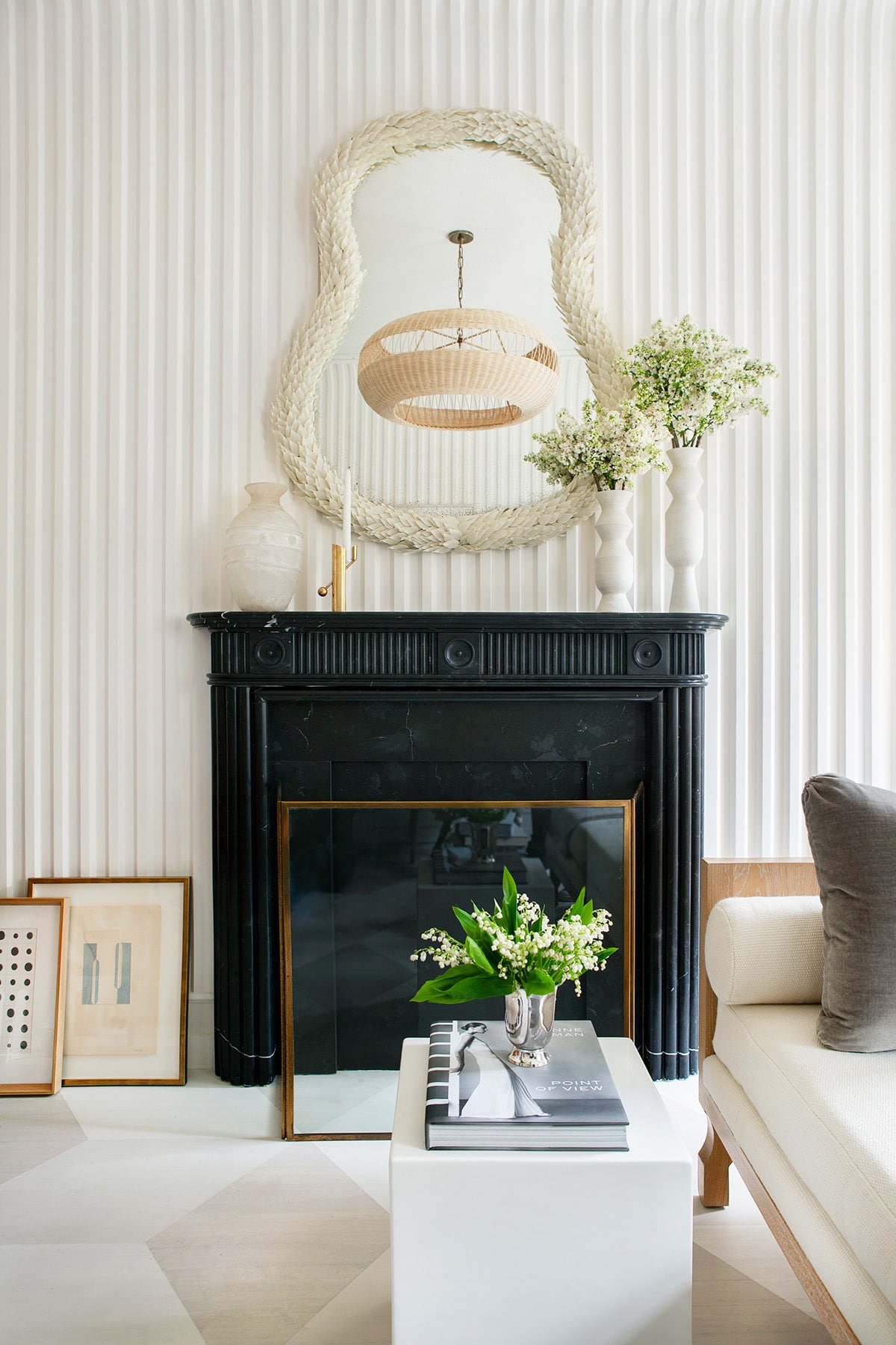 fluted plaster walls and a classic black fireplace in a sitting room kips bay showhouse by sarah bartholomew