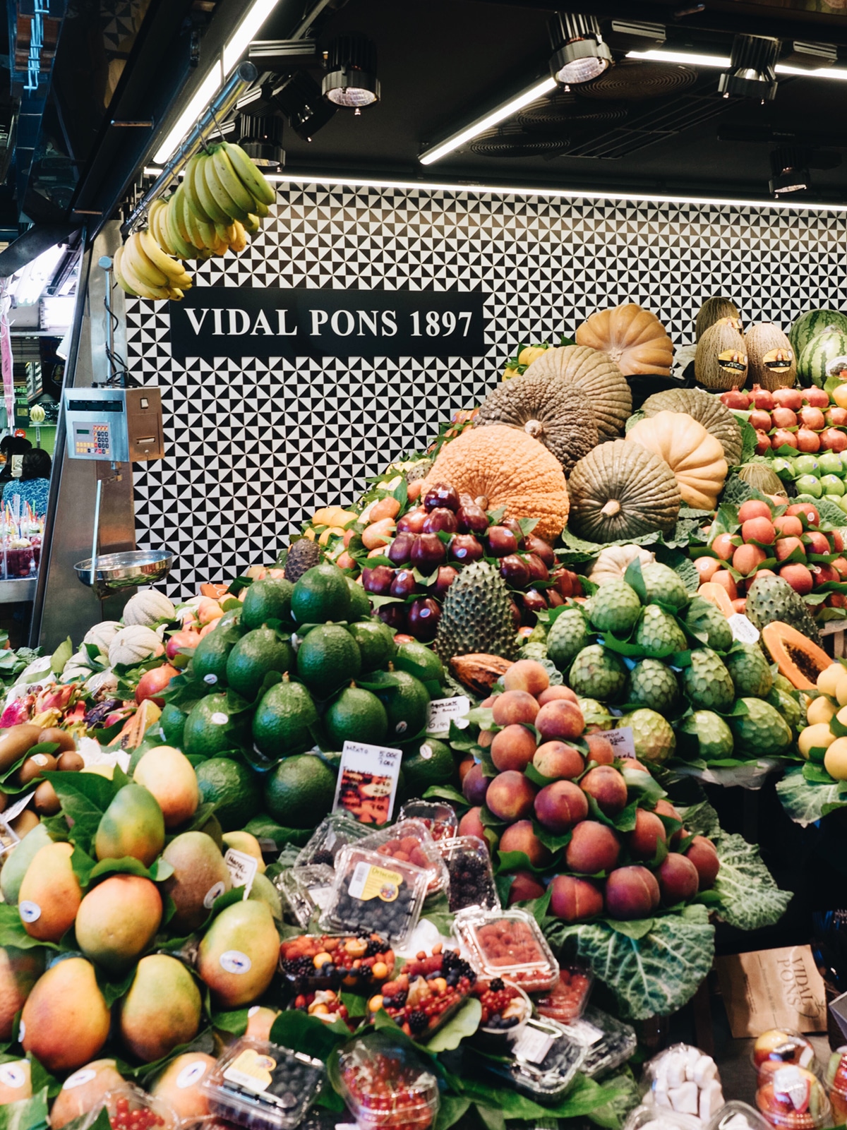 stacked fruit stands in la boqueria market | barcelona travel guide on coco kelley