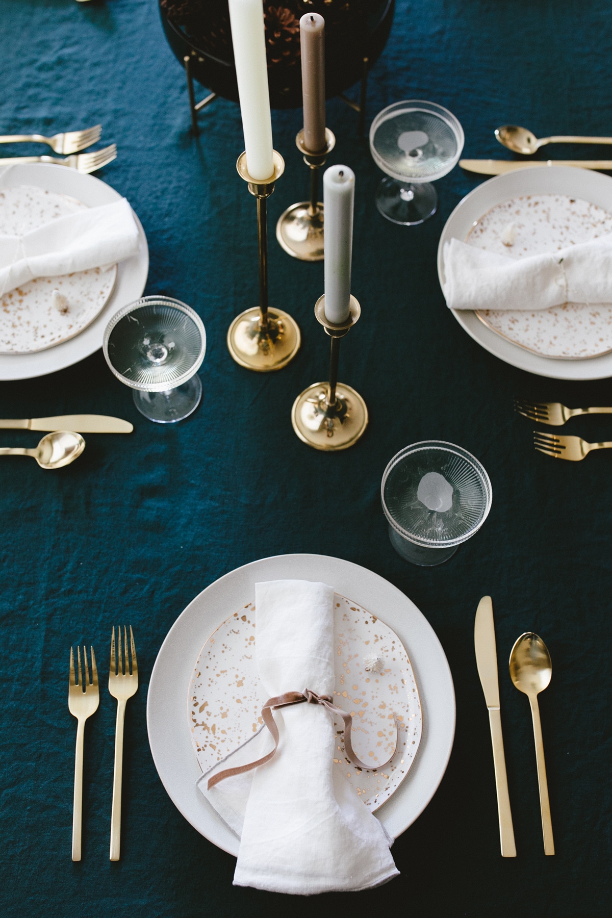 gold splatter paint dishes on a rich teal tablecloth | coco kelley holiday tabletop tutorial