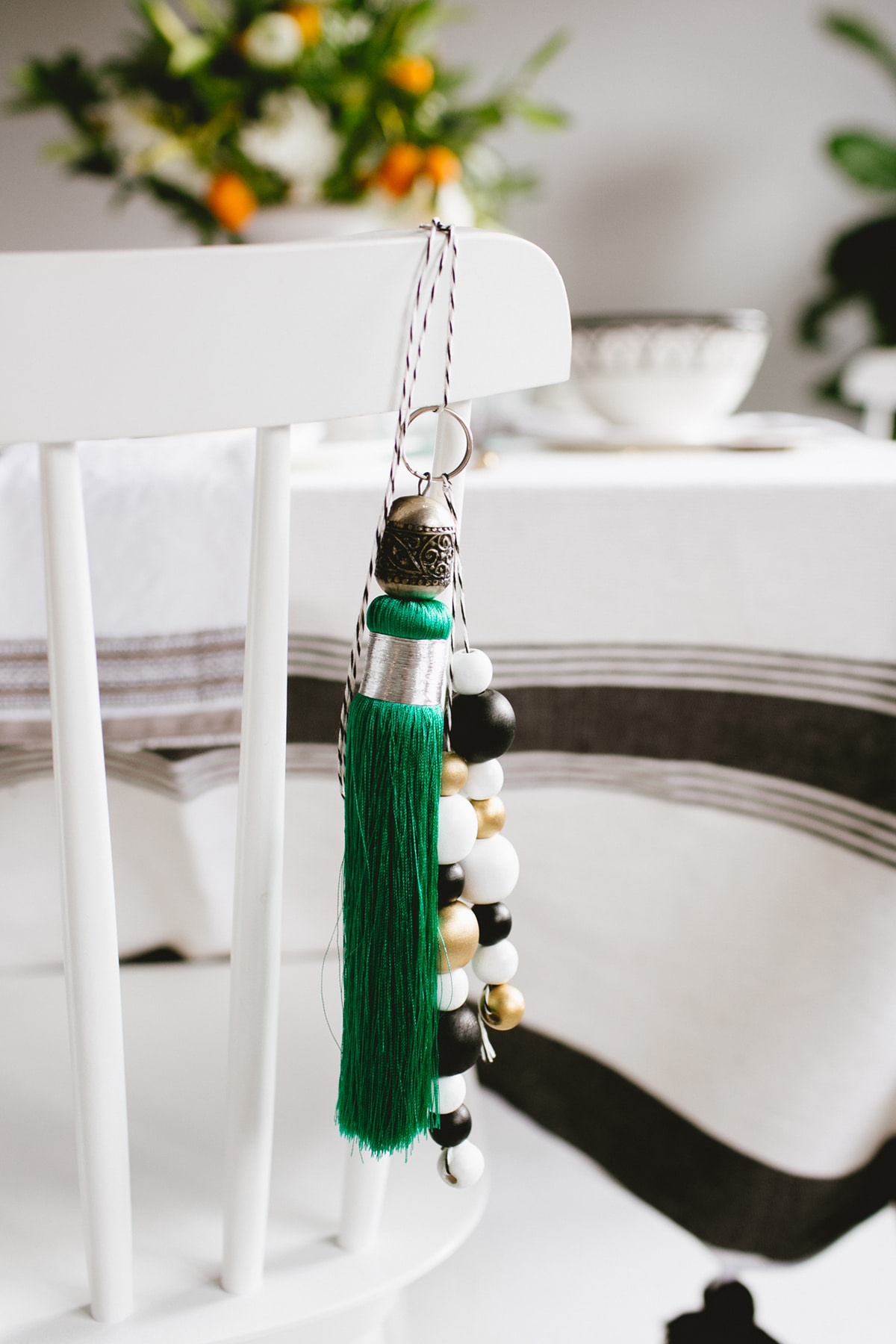 green tassel and wood beads as a gift for guests | moroccan tabletop by coco kelley