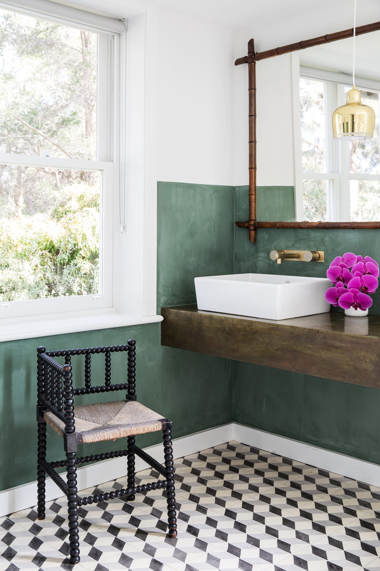 green walls and graphic black and white tile in the bath | coco kelley