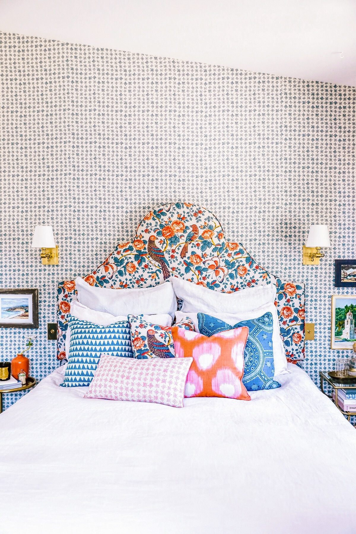 guest bedroom with layered pattern in blue, orange and pink | via coco kelley