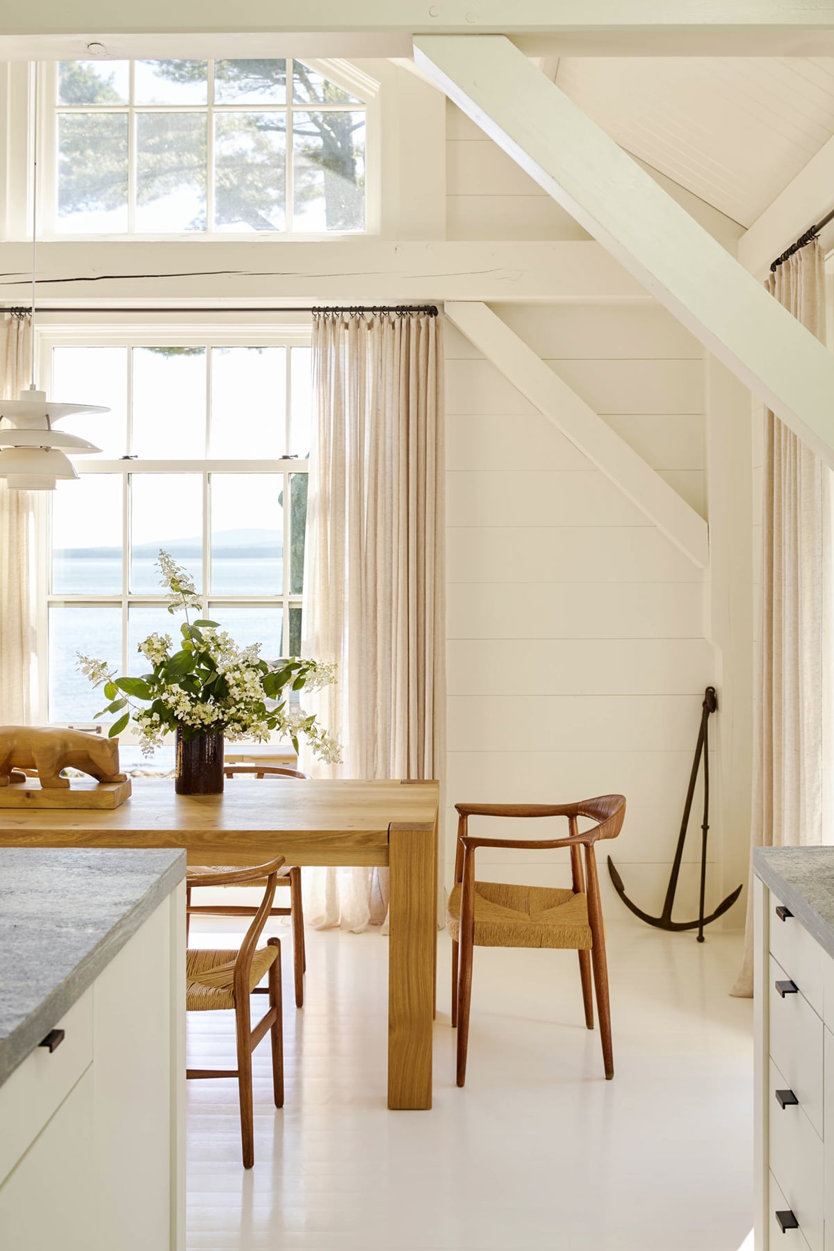 light filled dining room with organic wood simple style | seaside maine cottage house tour on coco kelley