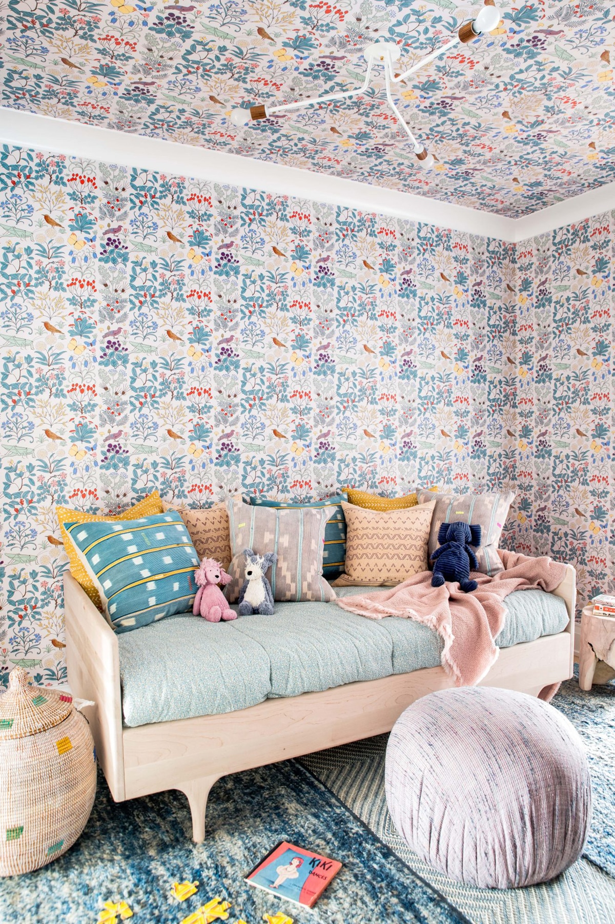 layers of pattern in the wallpaper rugs and daybed in this fun kids playroom! | house tour on coco kelley