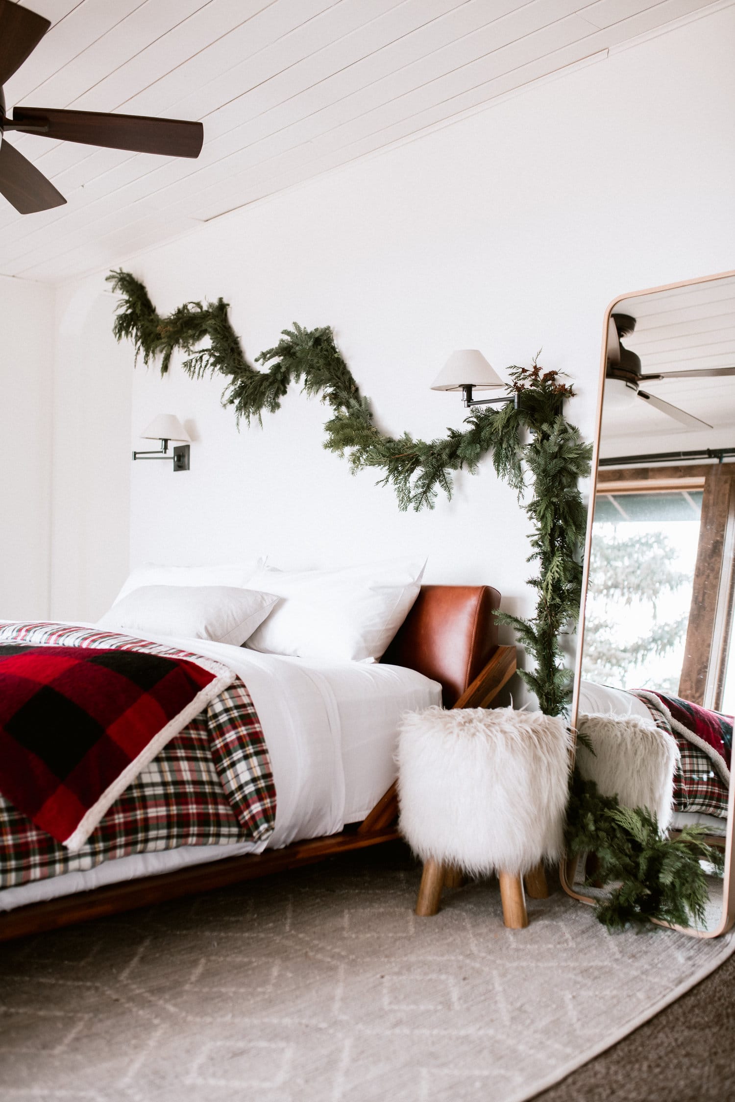 layers of plaid in the bedroom with a little greenery swag by simply suzy | our favorite holiday home decor on coco kelley