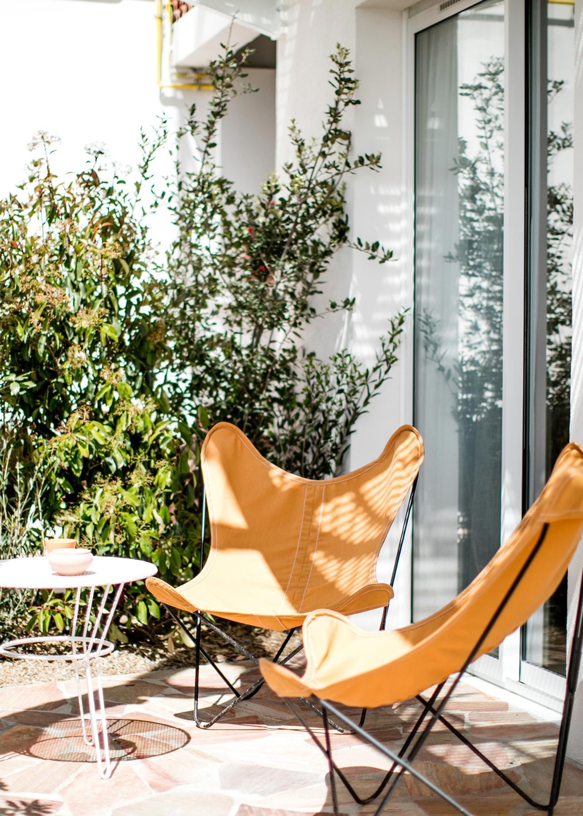 butterfly chairs on the patio | les roches rouges hotel in france